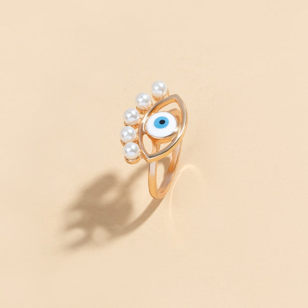 bague mauvais oeil dorée avec des perles 