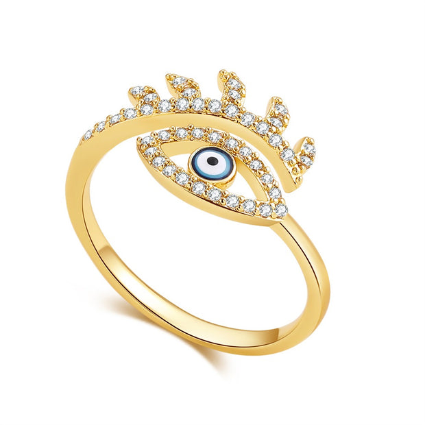 bague dorée avec symbole du mauvais oeil et ornée de strass type diamant 